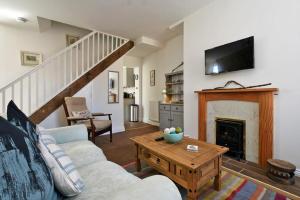 a living room with a couch and a fireplace at Sea Air in Amble