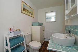 a bathroom with a sink and a toilet at Sea Air in Amble +8 photos