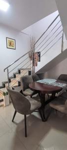a living room with a table and chairs and stairs at Night-Knight in Smederevo
