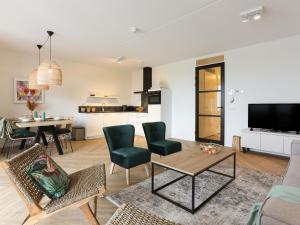 a living room with a table and chairs at Amazing apartment in Kamperland with patio in Kamperland