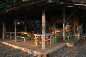 a group of tables and chairs under a pavilion at Art House at Chiangdao - Waterlily House in Chiang Dao