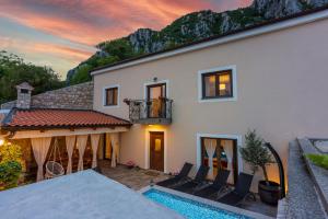 a villa with a swimming pool and a house at Villa Banely in Grižane