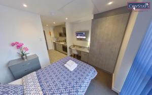 a small room with a bed and a desk in it at Signature House - Contemporary Studios in Coventry City Centre, free parking, by COVSTAYS in Coventry