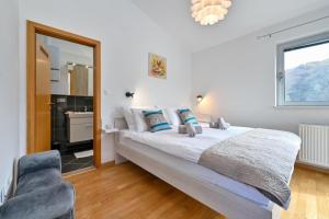 a bedroom with a bed and a mirror and a chair at Holiday Home Hanna Toplice Sveti Martin in Sveti Martin na Muri +57 photos