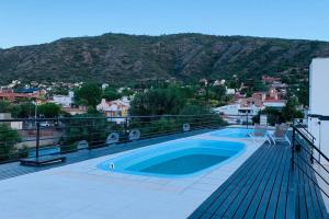 a swimming pool on the roof of a house at VOW Departamento CÉNTRICO CON COCHERA in Villa Carlos Paz +25 photos