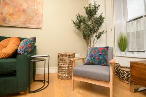 a living room with two chairs and a couch at Centrally Located Apartment - Pass the Keys in Lincoln