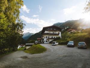 a group of cars parked in front of a house at The Studio by Apartment Wilky in Kaprun