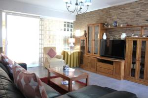 a living room with a couch and a tv at Casa Andreia, close to everything in Lagos