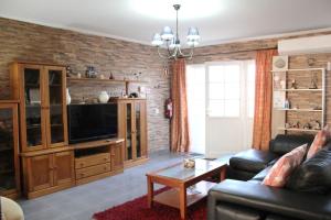 a living room with a couch and a tv at Casa Andreia, close to everything in Lagos
