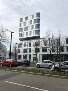 a large building with cars parked in front of it at F2 côté UGC climatisé plein centre parking gratuit in Strasbourg