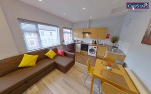 a living room with a couch and a table at Sunnyside View - 1-bed Apartment in Coventry City Centre in Coventry
