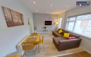 a living room with a couch and a table at Sunnyside View - 1-bed Apartment in Coventry City Centre in Coventry