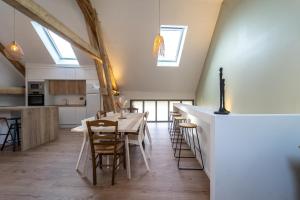 a kitchen and dining room with a table and chairs at Maison de Village - 291 in Duingt