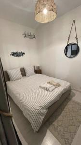 1 dormitorio con 1 cama con 2 toallas en Cosy et jardin panoramique en Morlaix