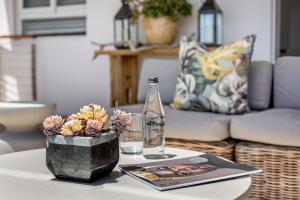 a coffee table with a glass bottle and a book at Far Horizons Camps Bay in Cape Town +72 photos