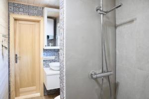 a bathroom with a shower with a toilet and a sink at Nadmorska Perełka in Rusinowo