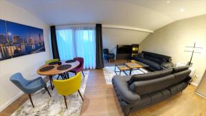 a living room with a couch and a table at Apart Hotel Maksimum in Belgrade
