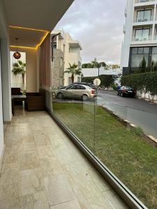 a balcony with a view of a street and a car at Luxury spacious 3 Bed apt with pool in Agadir