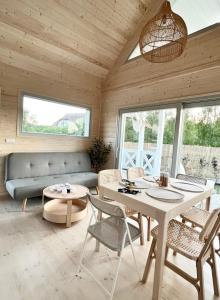 a living room with a couch and a table and chairs at Nadmorska Perełka in Rusinowo +24 photos