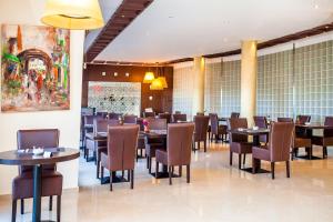 a dining room filled with tables and chairs at Relax Hotel Airport Nouasseur in Nouaseur