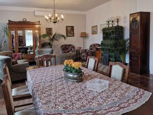 a dining room with a table with flowers on it at ZACZAROWALIM - Dom w Górach Sowich in Walim