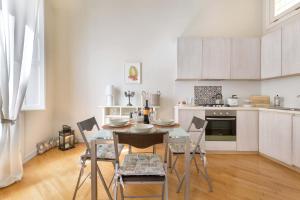 a kitchen with a table and chairs in a room at Barocco Dream by BarbarHouse in Lecce