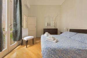 a bedroom with a bed and a chair and a window at Barocco Dream by BarbarHouse in Lecce
