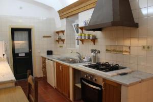 a kitchen with a sink and a stove top oven at Casa de Viana do Alentejo in Viana do Alentejo