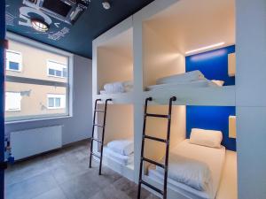 a bunk bed room with three bunk beds and a window at Main Square Hostel in Zagreb