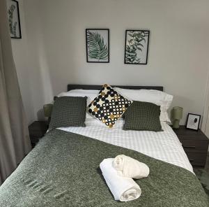 a bedroom with a bed with towels on it at Honeybee House in Redcar