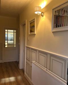 a hallway of a home with a staircase and a window at Honeybee House in Redcar