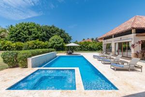 a swimming pool in the backyard of a house at Casa de Campo Luxury Villas - Private Paradise at La Romana in La Romana