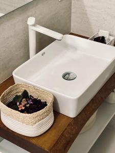 a white sink on a counter with a basket at RESIDENCE OLD STORIES in Barile