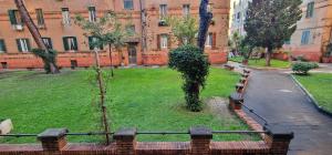 a park with two trees and a building at R.&T. Suite House Roma in Rome