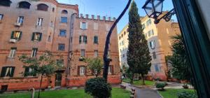 a view of an old building from a window at R.&T. Suite House Roma in Rome