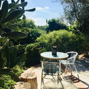 a table and two chairs sitting on a patio at Lovely quinta in nature with pool - Tomar in Pero Calvo