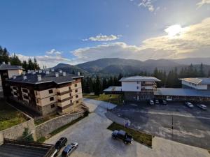 an aerial view of a building with a parking lot at Pamporovo Rhodopi Pearl Apartments - Private Apartments in Pamporovo