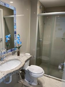 a bathroom with a toilet and a sink and a shower at VG FUN 308 Praia do Futuro in Fortaleza