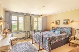 a bedroom with a bed and a chair at Luxury Raesborre Domain in Leuven