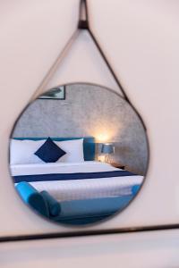 a reflection of a bedroom with a bed in a mirror at Joi Hospitality - Front Beach in Vung Tau