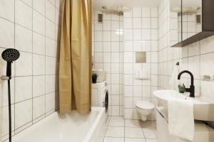 a bathroom with a toilet and a sink and a shower at Central, modern city apartments - by homekeepers in Würzburg