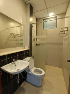 a bathroom with a toilet and a sink at The Retreat Sweety 3BR H/Stay in Brinchang