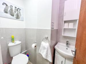 a small bathroom with a toilet and a sink at Baxter House in Boston