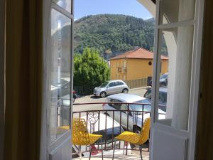 a view of a balcony with chairs and a table at Appartement Lumea 80 m2 climatisé parking proche Sanctuaires in Lourdes