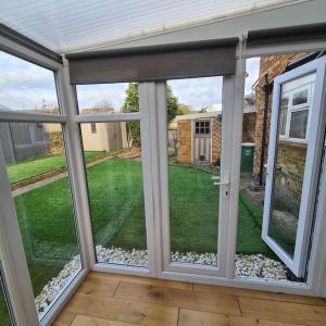 a screened in porch with a view of a yard at Lovely Home away from home! in Bexleyheath
