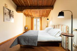 a bedroom with a bed and a window at Attico Amorino in Florence