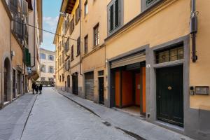 an empty alley with people walking down the street at Attico Amorino in Florence