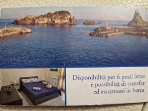 a picture of a room with a bed in the water at L'Isola e i Faraglioni house in Acitrezza