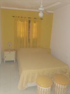 1 dormitorio con 1 cama y 2 taburetes en CONFORTABLE DUPLEX CON GARAGE en Santiago del Estero