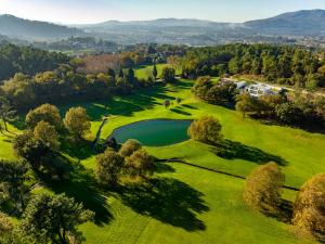 an aerial view of a golf course with a pond at Golf Course - Luxurious Flat T3 - Ponte de Lima in Ponte de Lima